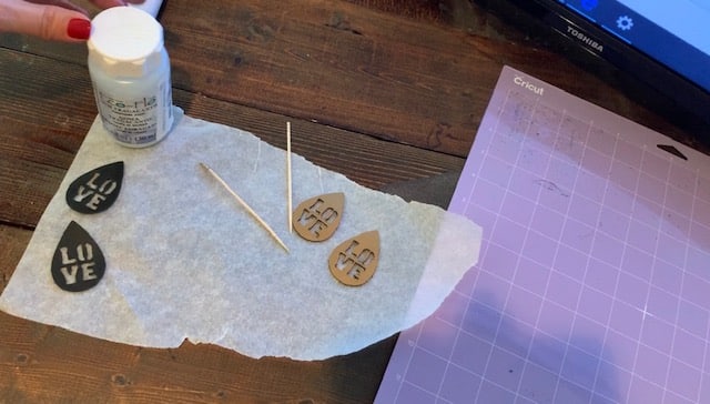 smooth edges of leather earrings to control flyaways