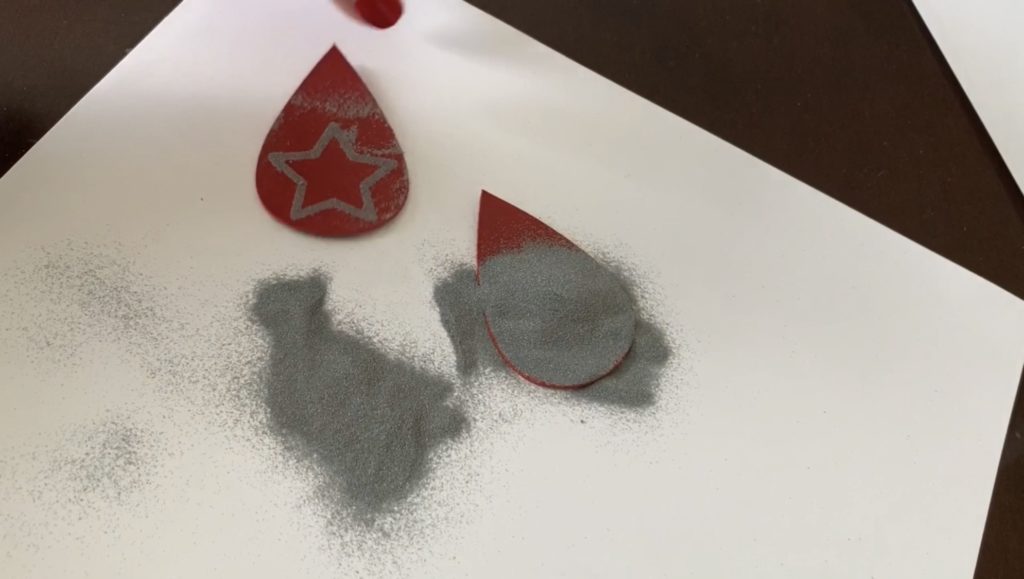 Embossing powder poured on top of the diy earring
