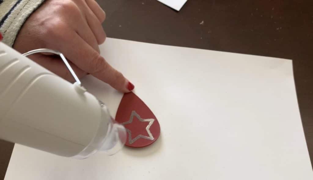 using heat tool on embossing powder for the How to Emboss Leather Earrings Project