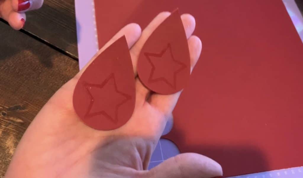 leather earrings cut and marked with embossing pen