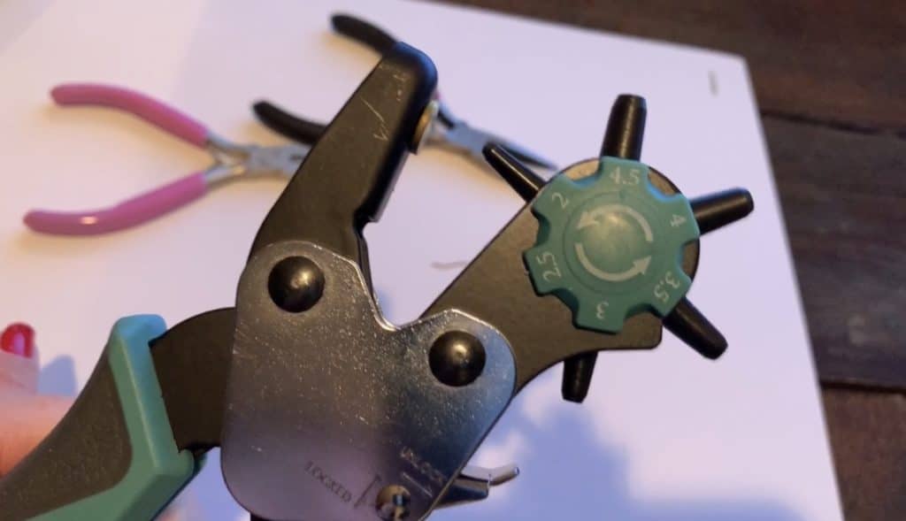 use leather hole punch to punch hole in diy faux leather earrings and diy leather earrings