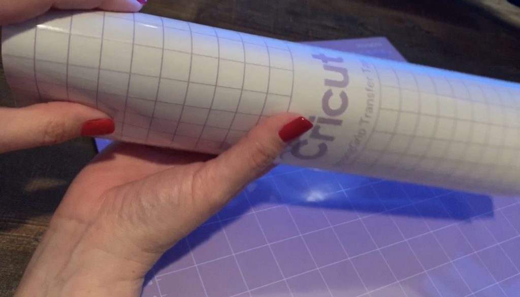 putting strong grip transfer tape onto strong grip Cricut mat to protect it from leather