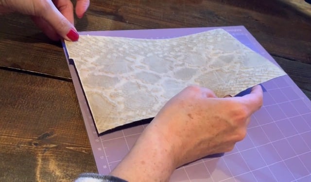 placing genuine leather on the Cricut strong grip mat with the good side facing down