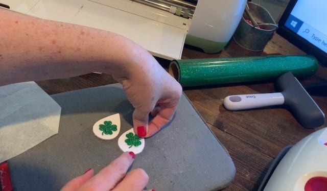 place shamrocks onto the leather earrings