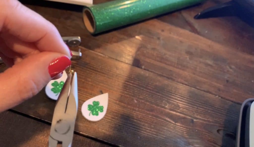 adjusting the earring hook with ball, using pliers