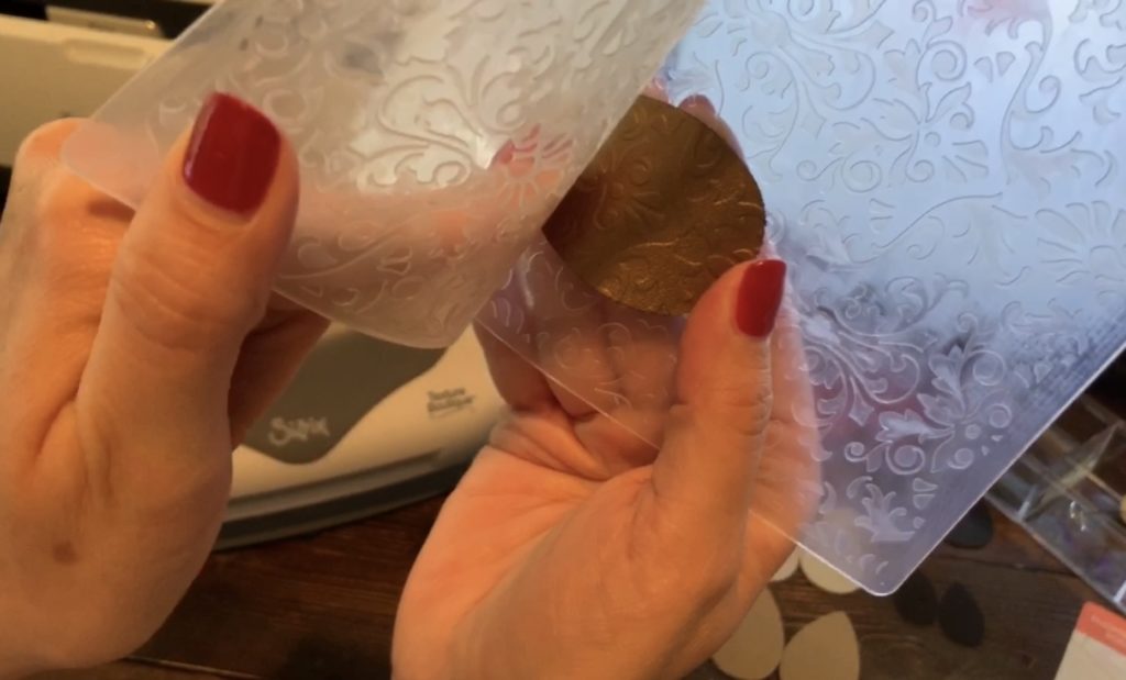 checking to see if leather earring is embossed before removing from embossed folder