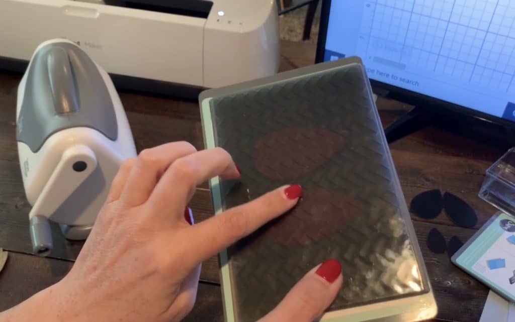 leather earrings in an embossing folder