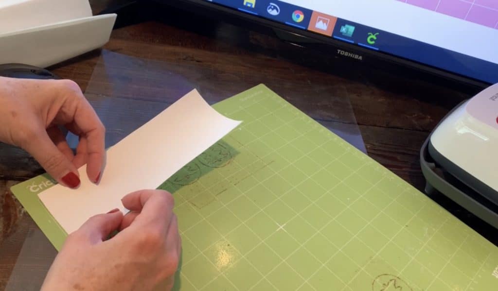 putting transfer tape on the Cricut mat