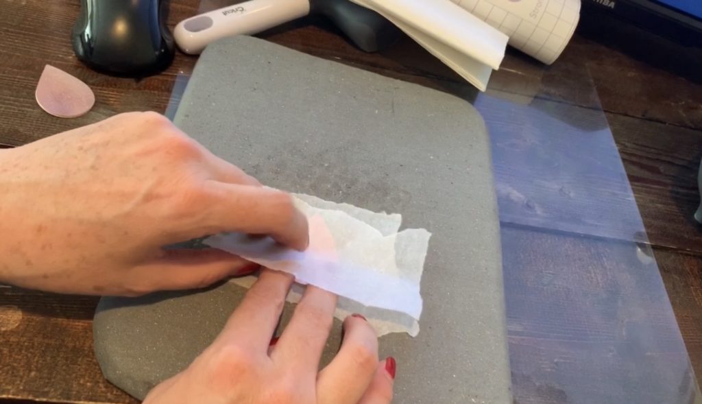 parchment paper on diy faux leather earring before putting on Easy Press