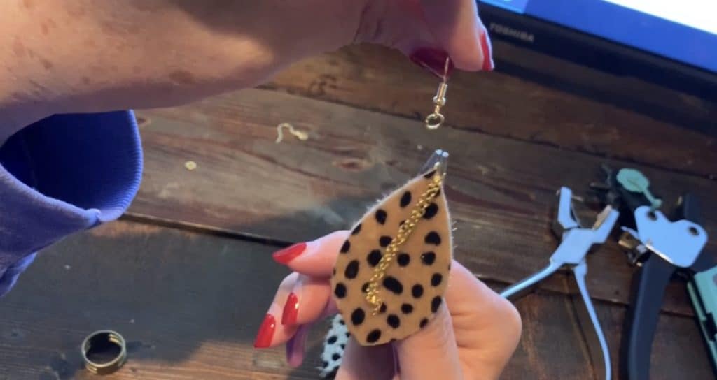 putting hook and jump ring onto the jump ring with the earring and chain