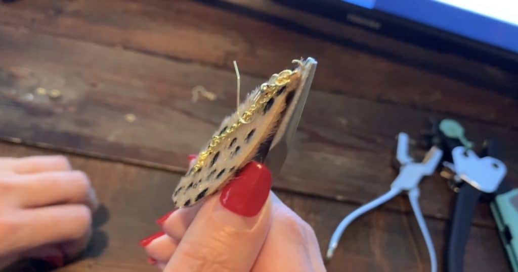 putting hook and jump ring onto the jump ring with the earring and chain