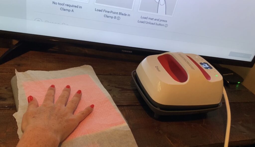 parchment paper on faux leather earrings before the Cricut Easy Press is placed on
