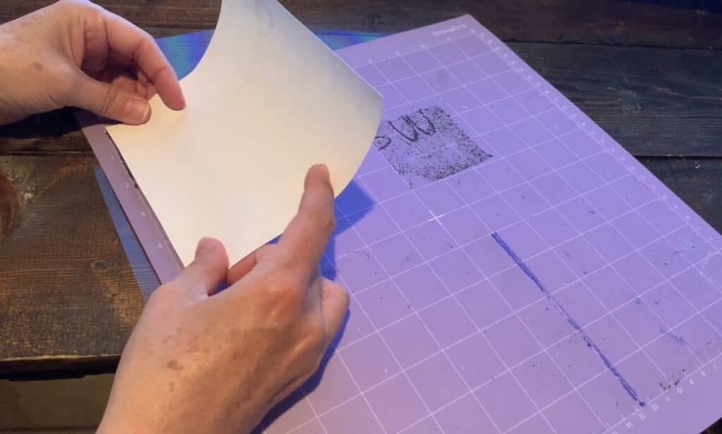 putting the strong grip transfer tape onto the cricut mat