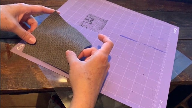 placing leather onto mat