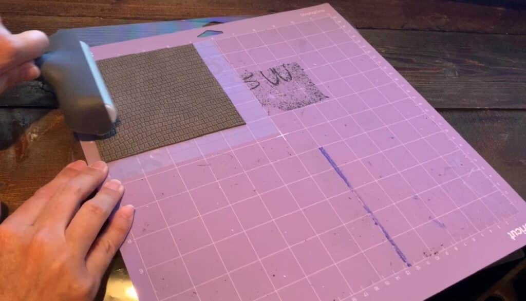 using cricut brayer to press leather on mat