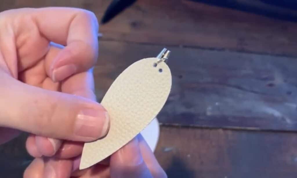 putting leather pinched earring onto the jump ring