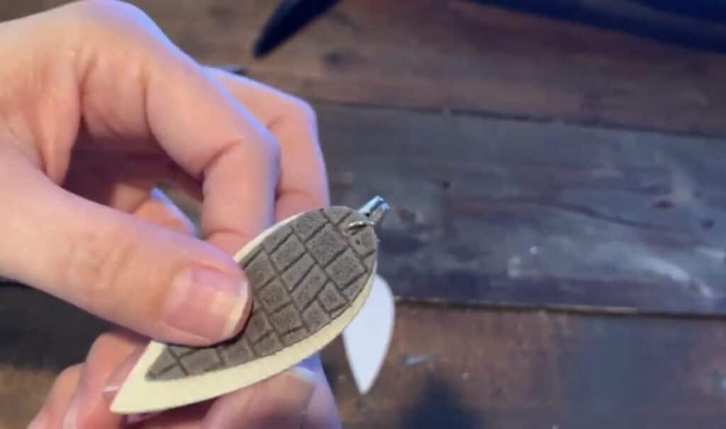 putting leather pinched earring onto the jump ring