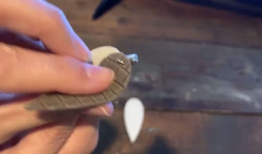 putting leather pinched earring onto the jump ring