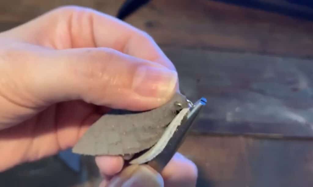 putting leather pinched earring onto the jump ring