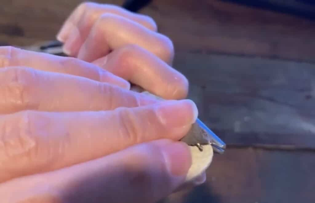 putting leather pinched earring onto the jump ring