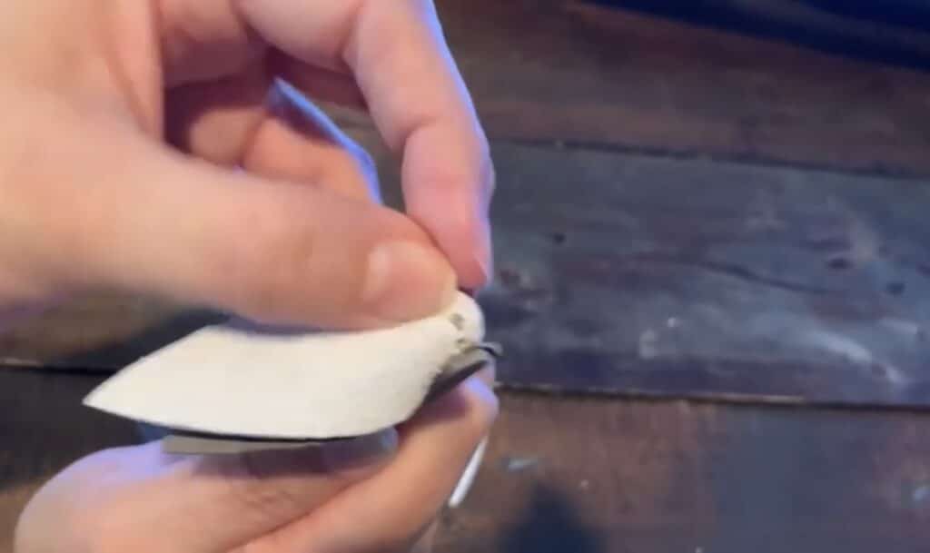 putting leather pinched earring onto the jump ring