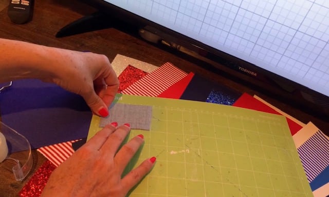 putting glitter faux leather onto cricut cutting mat