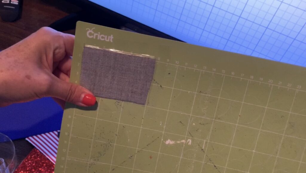 putting glitter faux leather onto cricut cutting mat