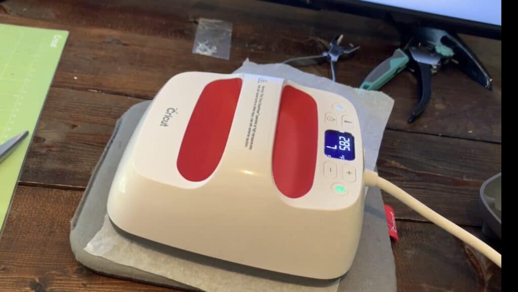Cricut Easy Press, used on top of two pieces of faux leather with Heat N Bond in between