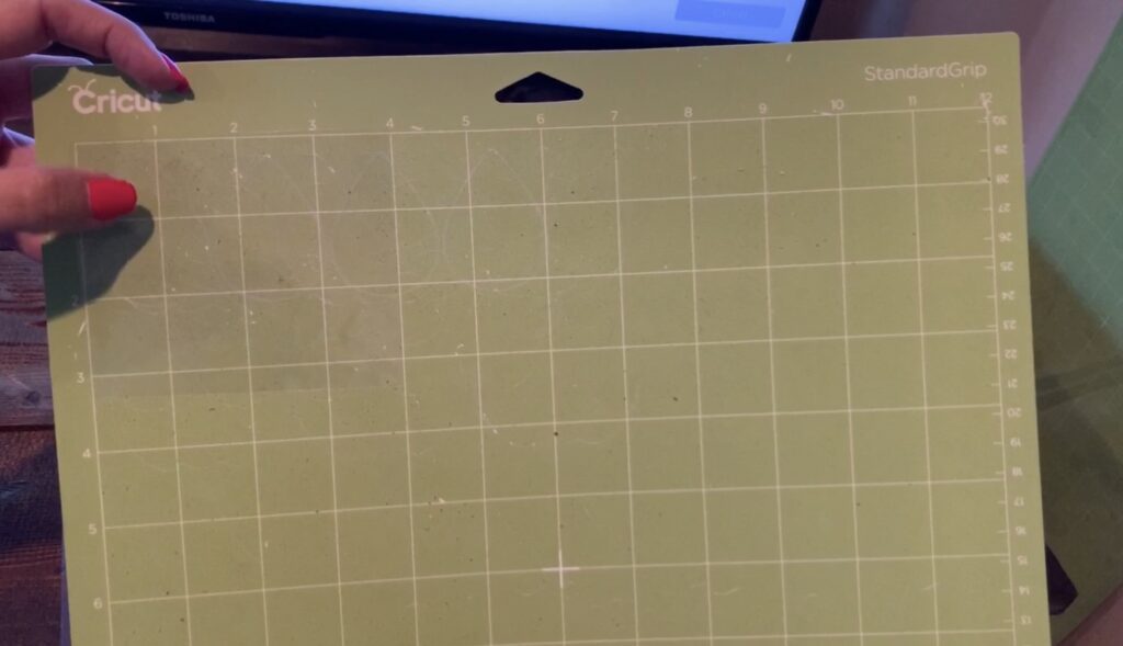 putting transfer paper on cricut mat
