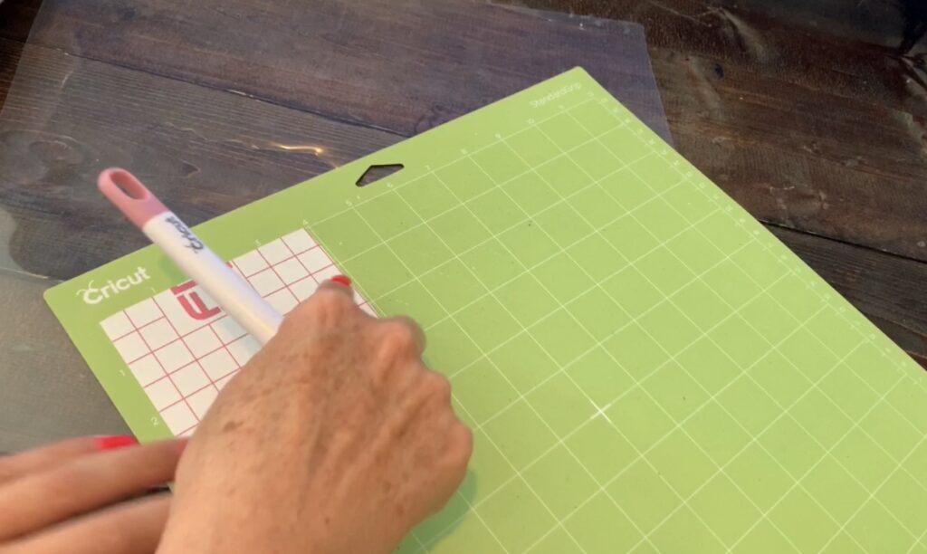 putting transfer paper on a Cricut standard grip mat to make diy earrings