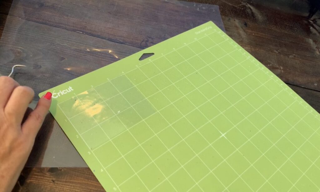 putting transfer paper on a Cricut standard grip mat to make diy earrings