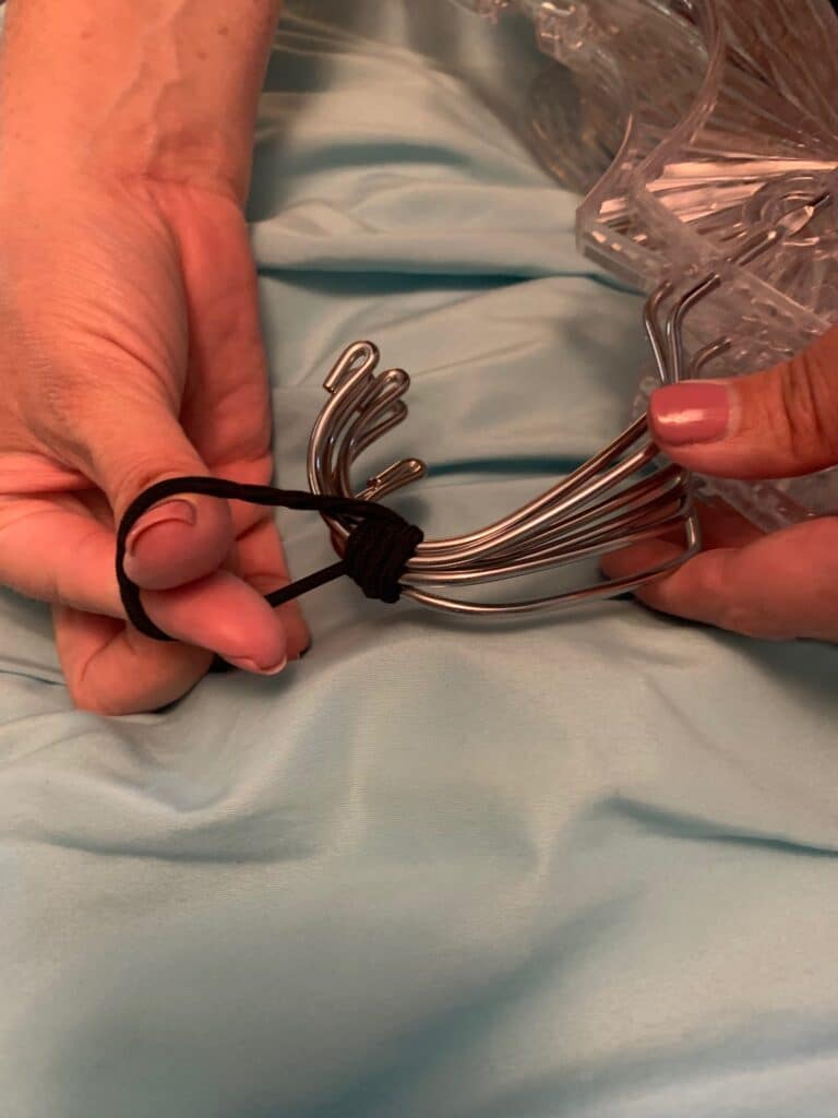 covering hung clothes with a trash bag for college move in day