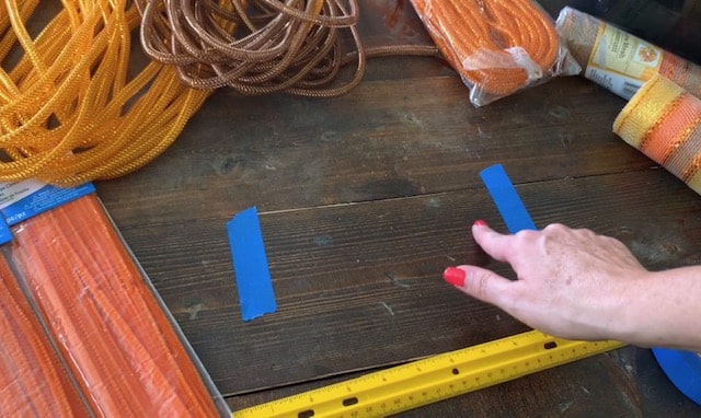 tape on table for measuring the dollar tree mesh for pumpkin wreath