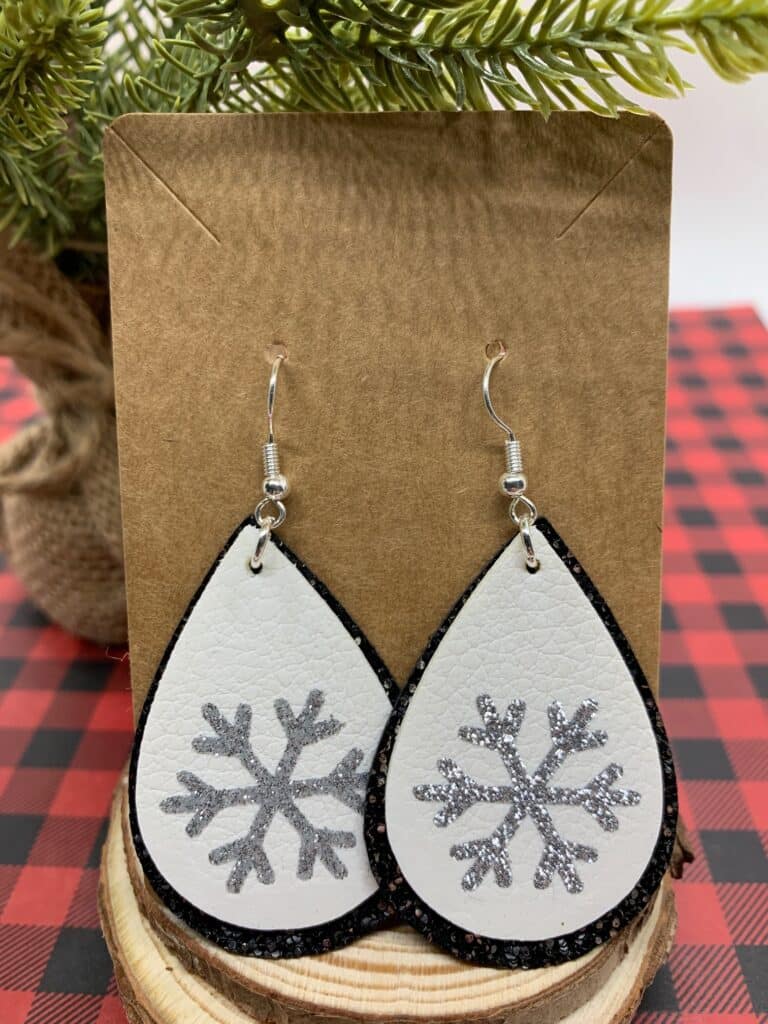 faux leather snowflake earrings with fine black glitter leather and double sided white leather