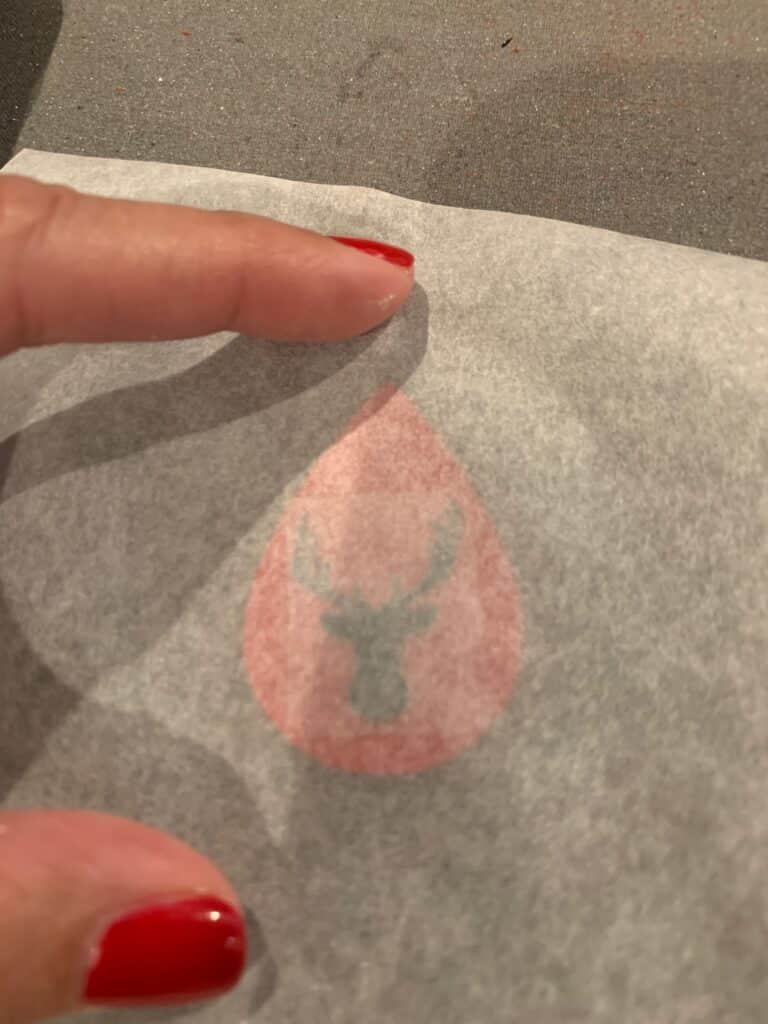 placing parchment paper on top of heat transfer vinyl before applying heat to the faux leather