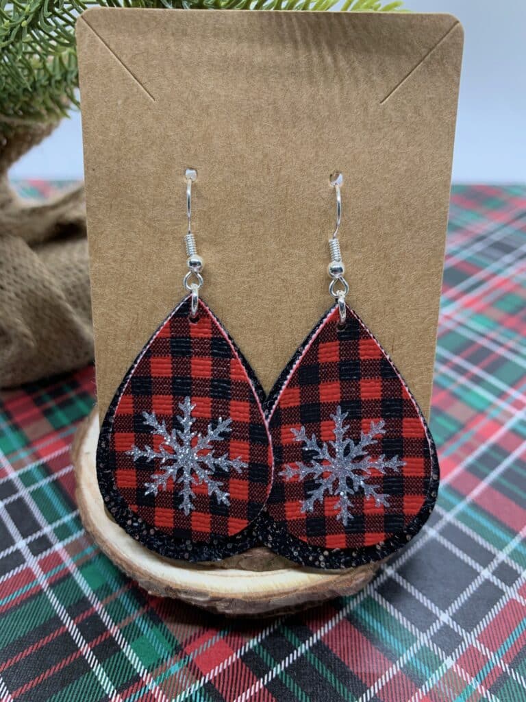 diy snowflake earrings made with mini red and black buffalo check faux leather and black and silver speckled faux leather