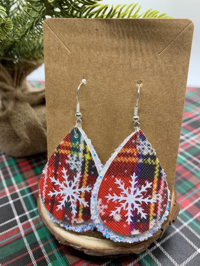 diy snowflake earrings made with chunky white glitter faux leather and snowflake plaid faux leather