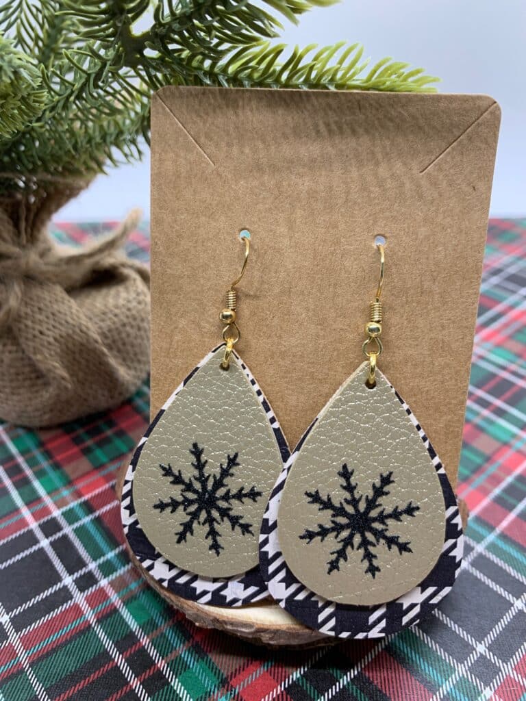 diy snowflake earrings made with black and white houndstooth faux leather and double sided gold faux leather