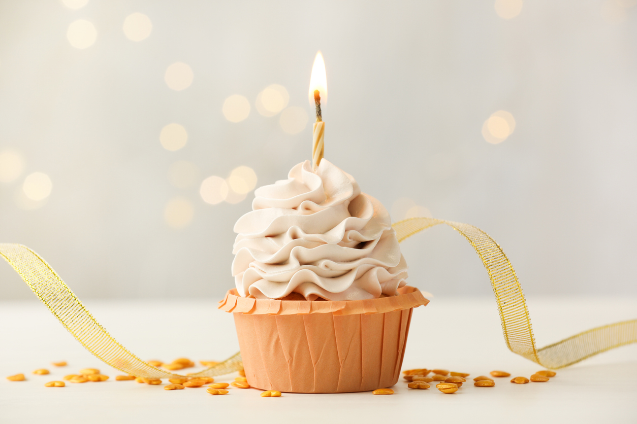 cupcake with frosting and a lit candle