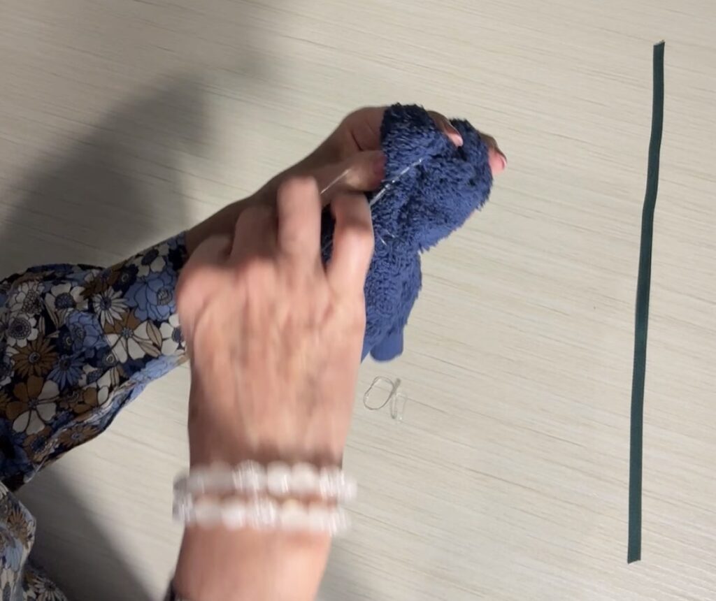 Ribbon tied around the washcloth bear’s neck to cover the rubber band and finish the look.