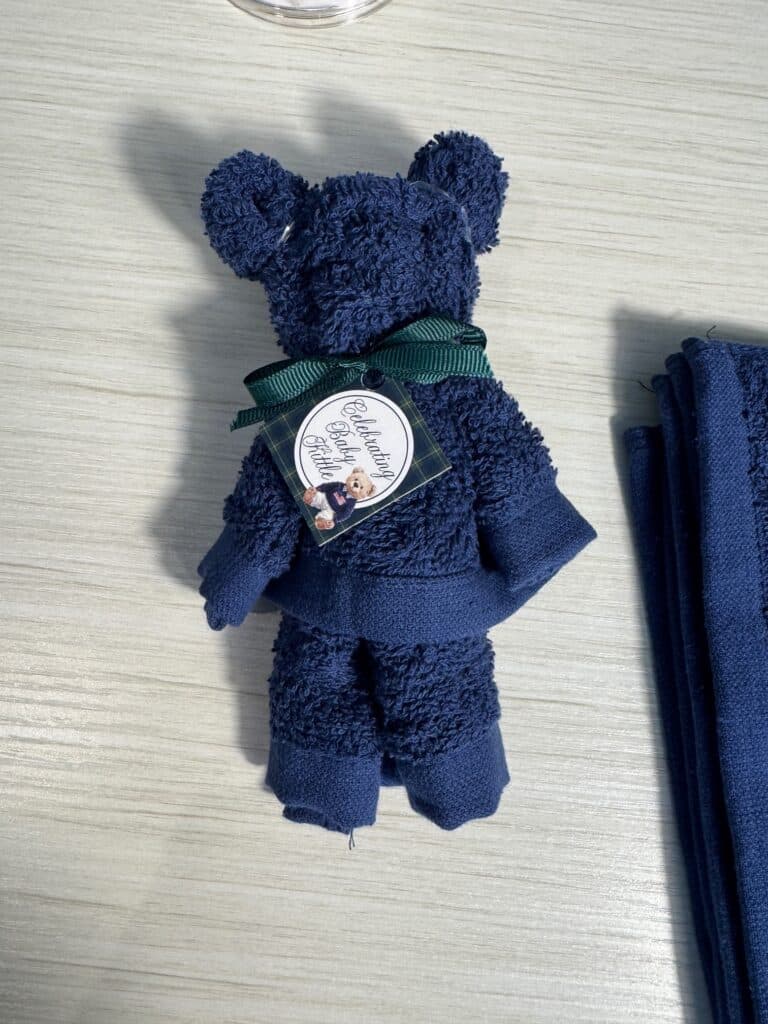 Finished washcloth bear with a small tag attached for gifting or party favors.